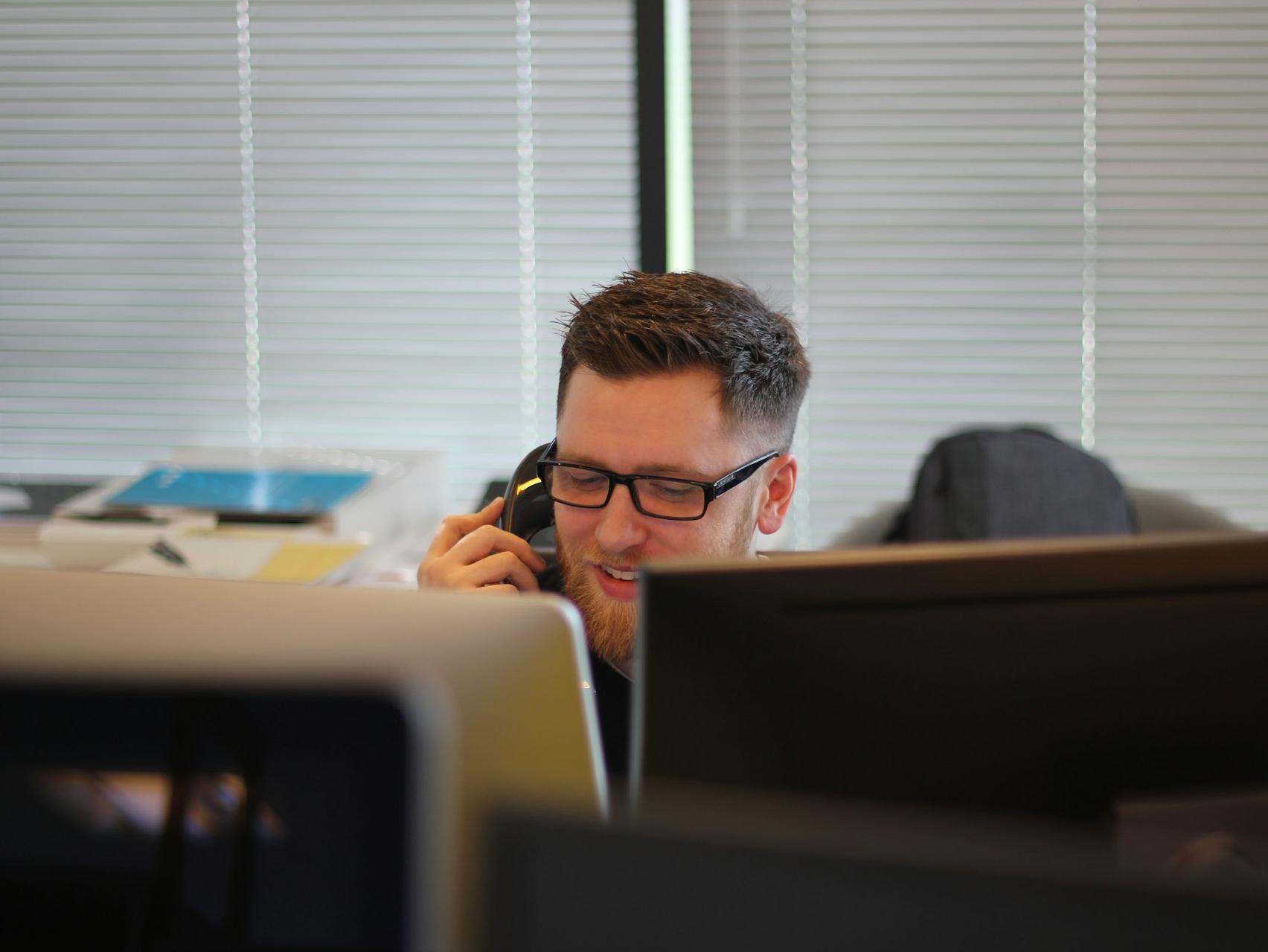 man using IP phone inside room